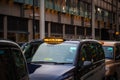 London black cabs lined up on sidewalk waiting for customers outside Kings Cross station Royalty Free Stock Photo