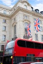 London Bus and UK flags in Piccadilly Circus Royalty Free Stock Photo