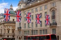 London Bus and UK flags in Piccadilly Circus Royalty Free Stock Photo
