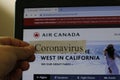 London Canada, March 01 2020: Editorial illustrative photo of a coronavirus label infront of Air Canada Website. Air