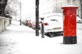 London classic red mailbox  under the falling snow Royalty Free Stock Photo