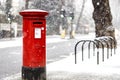 London classic red mailbox  under the falling snow Royalty Free Stock Photo