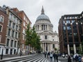 London crowds walking toward St. Paul's cathedral on a rainy day