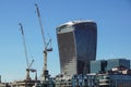 LONDON, ENGLAND - APRIL 25: the `Gherkin` between two skyscrapers under construction in the City of London on May 25 Royalty Free Stock Photo