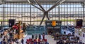 Passengers at London Heathrow`s Terminal 5 with view to outside airplanes and other terminals