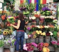 Woman tends to her flower kiosk in London, England