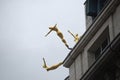 London / England - August 11, 2014: Golden statues on a building of London.