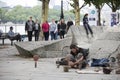Man makes sculptures of stones on the waterfront
