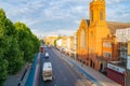 London, England - August 7 2017; Sunsets at far end Mile End Road with vehicles moving along the street, people and red brick Royalty Free Stock Photo