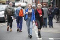 Two fashionable blonde girls walk past Brick Lane