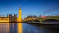 London, England - The Big Ben Clock Tower and Houses of Parliament with iconic red double-decker buses at city of westminster by Royalty Free Stock Photo