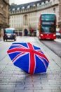 London, England - British umbrella at Regent Street with iconic red double-decker bus and black taxi Royalty Free Stock Photo
