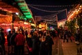 LONDON, ENGLAND, DECEMBER 28, 2018: People enjoying a pleasant time in a Christmas market, surrounded by food and drink stands,