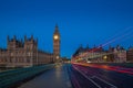 London, England - The famous Big Ben and Houses of Parliament with lights of double decker buses Royalty Free Stock Photo