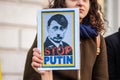 LONDON, ENGLAND- 26 February 2022: Putin Hitler placard at a protest against Russia`s invasion of Ukraine