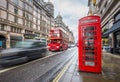 London, England - Iconic blurred black londoner taxi and vintage red double-decker bus on the move Royalty Free Stock Photo