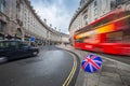 London, England - Iconic red double-decker bus and black taxi on the move on Regent Street Royalty Free Stock Photo