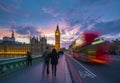 London, England - Iconic Red Double Decker Bus on the move on Westminster Bridge with Big Ben and Houses of Parliament Royalty Free Stock Photo