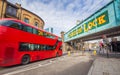 London, England - Iconic red double decker bus on the move at the world famous stables market of Camden Town Royalty Free Stock Photo