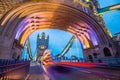 London, England - Iconic red double decker buses on the move on the beautiful Tower Bridge