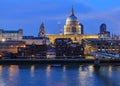 View of the famous St. Paul's Cathedral across the river Thames with Millennium Bridge in London, England Royalty Free Stock Photo