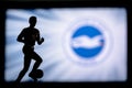 LONDON, ENGLAND, JULY. 1. 2019: Brighton Hove Albion Football club logo, Premier League, England. Soccer player silhouette Royalty Free Stock Photo