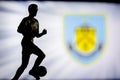 LONDON, ENGLAND, JULY. 1. 2019: Burnley Football club logo, Premier League, England. Soccer player silhouette Royalty Free Stock Photo