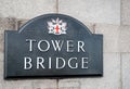 City of London Tower Bridge sign with city crest mounted on stone bridge tower