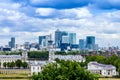 Skyline view of the skyscrapers of Canary Wharf and national maritime museum, shot from Greenwich park at sunset - London, UK Royalty Free Stock Photo