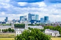 Skyline view of the skyscrapers of Canary Wharf and national maritime museum, shot from Greenwich park. London, UK Royalty Free Stock Photo