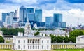 Skyline view of the skyscrapers of Canary Wharf and national maritime museum, shot from Greenwich park. London, UK Royalty Free Stock Photo