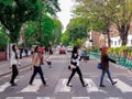 Large image of four beatles female fans walking across the so famous Abbey Road Zebra Crossing