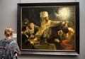 Visitor looking at painting of Rembrandt in National galleryin London