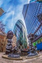 The famous Gherkin Tower with statues on street. London Royalty Free Stock Photo