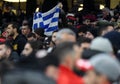 A Greek fan displays a Greece flag