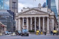 London, England - The Royal Exchange building with moving traditional black london taxies Royalty Free Stock Photo