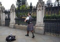 LONDON England - 08/21/2019: scottish bagpiper knocking on the door of the English parliament