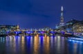 London, England skyline at night with the Shard, Southwark Bridge and Tower Bridge on Thames river with night lights