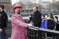 London, England: 8th March 2018: A man dressed in British flag jacket and sunglasses and a `London` hat selling tickets outside