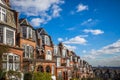 London, England - Traditional brick houses and flats on a nice summer morning with blue sky and clouds Royalty Free Stock Photo
