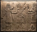 London, United Kingdom - Ancient Assyria clay tablet relief of protective spirits, from king Ashurbanipal royal palace in Nineveh Royalty Free Stock Photo