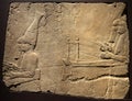 London, United Kingdom - Ancient Assyria clay tablet relief of royal musicians from king Ashurbanipal royal palace in Nineveh at Royalty Free Stock Photo