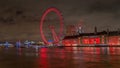 London eye lit with colorful lights at night from the Westminster bridge over river Thames Royalty Free Stock Photo