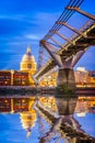 London, England - United Kingdom. St Paul Anglican dome and Millennium Bridge, early in the evening twilight Thames River Royalty Free Stock Photo