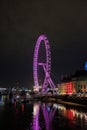 The London Eye being lit with purple light. Gorgeous lights illuminating the surrounding