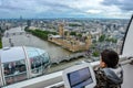 The London Eye Capsule - Young Boy looking out window at Skyline Royalty Free Stock Photo