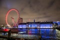 The London Eye ferris wheel illuminated city night