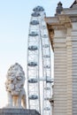 London eye, ferris wheel and lion bridge statue in London