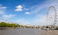 london eye. located next to a beautiful river and a view of the city