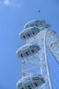 The London Eye or the Millennium Wheel with a helicopter overflying in London, UK